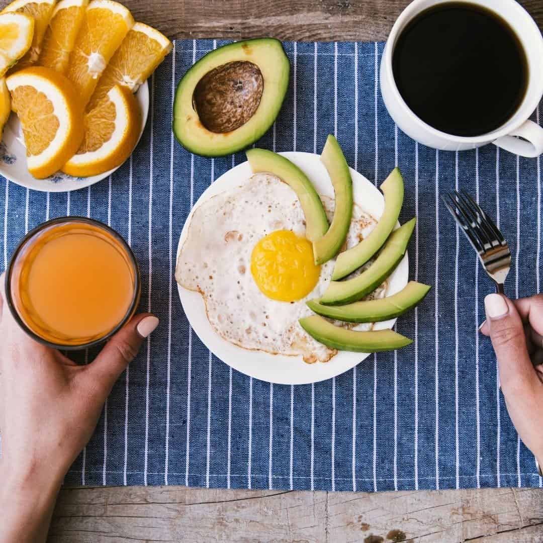 Gluten-free eating on the go at a restaurant. Gluten-free breakfast option of eggs, fruit, avocado, coffee, and juice.