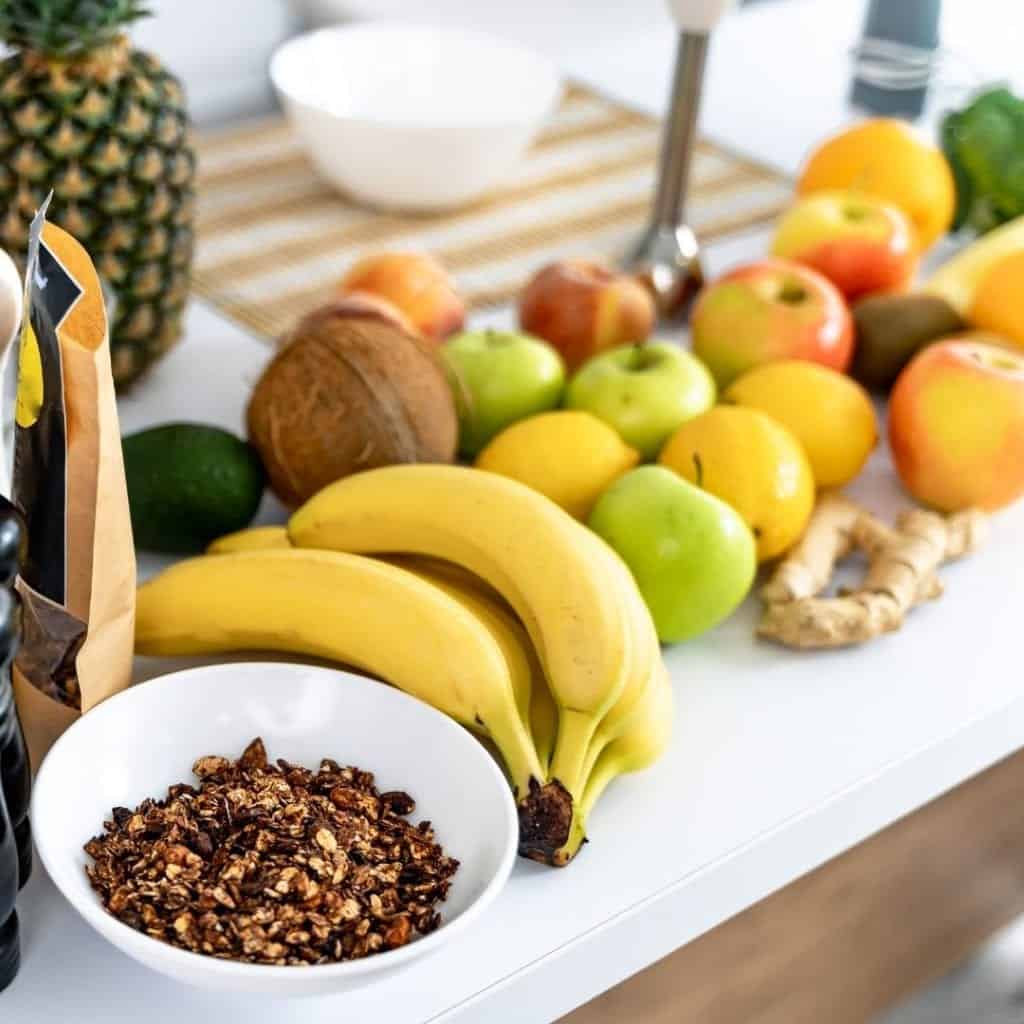 Healthy fruits such as bananas, ginger, apples. lemon and granola from a healthy shopping trip full of tips for busy person.