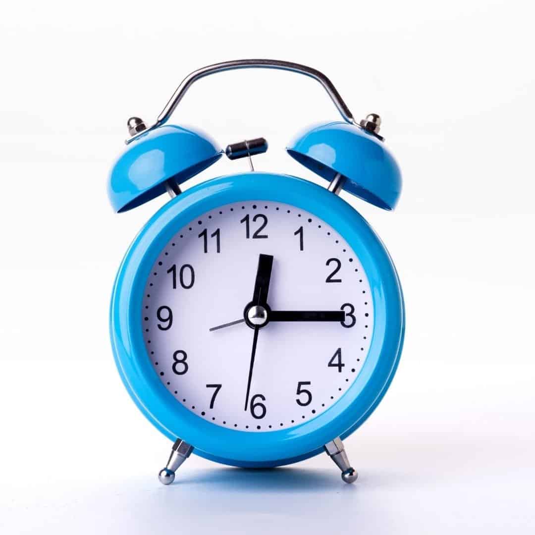 Blue alarm clock symbolizes time management strategies to boost productivity.