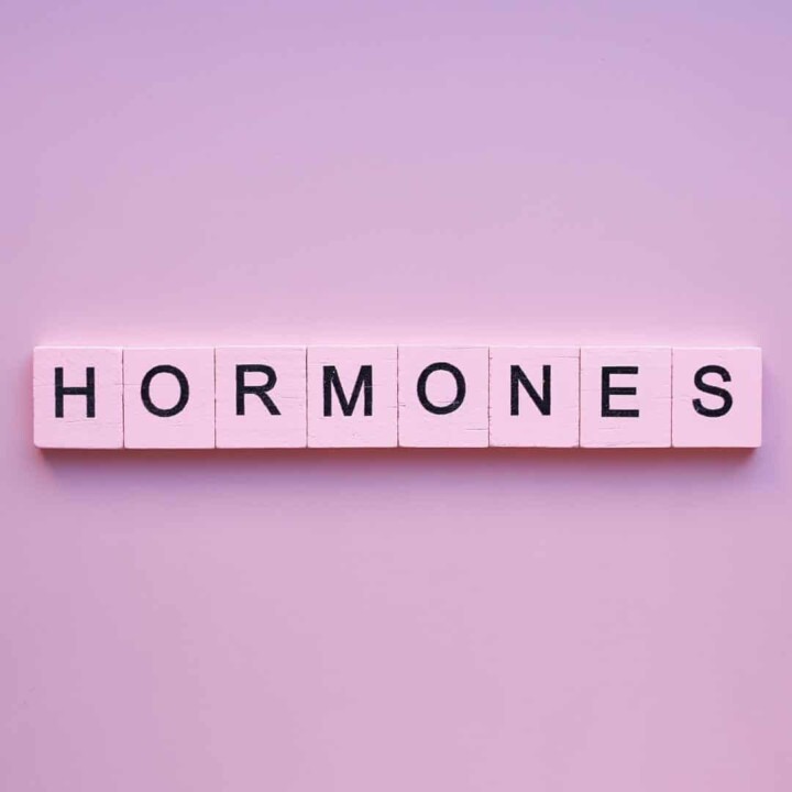 Pink scrabble tiles spelling out the word hormones.