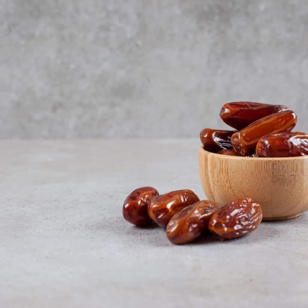 Wooden bowl filled with antioxidant-rich dates.