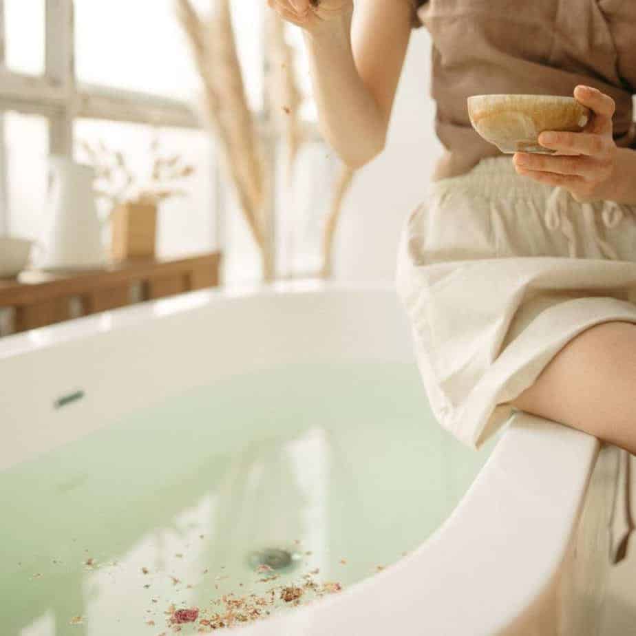 Caring for yourself in a hot bath with natural herbal remedies to get PMS relief. 