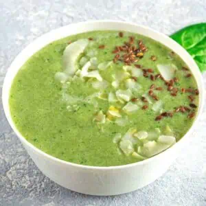 Green smoothie made with avocado, drizzled with cashew cream.