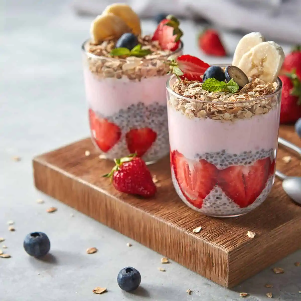 Chia seeds in a cup topped with berries and bananas are the best ways to eat chia seeds for nutrition and health benefits.