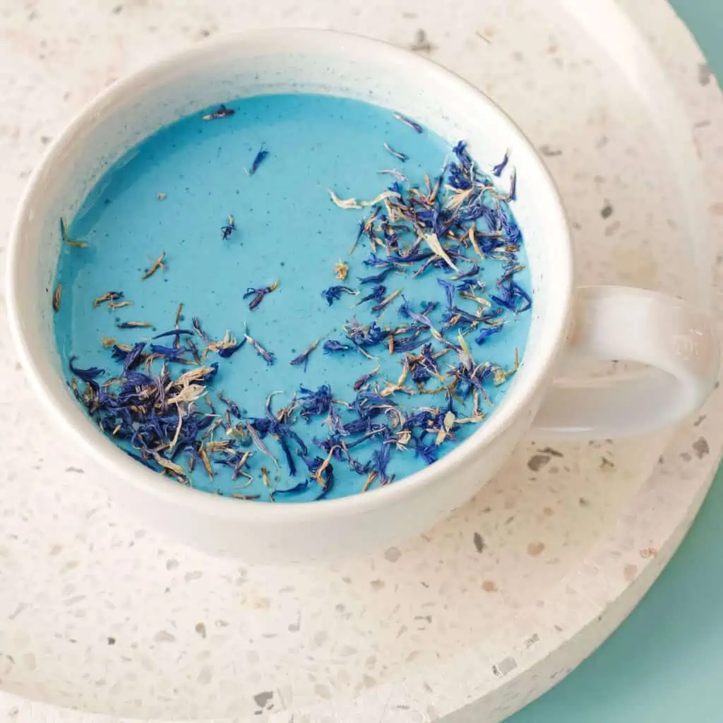 Relaxing moon milk in a ceramic cup with dried lavender.