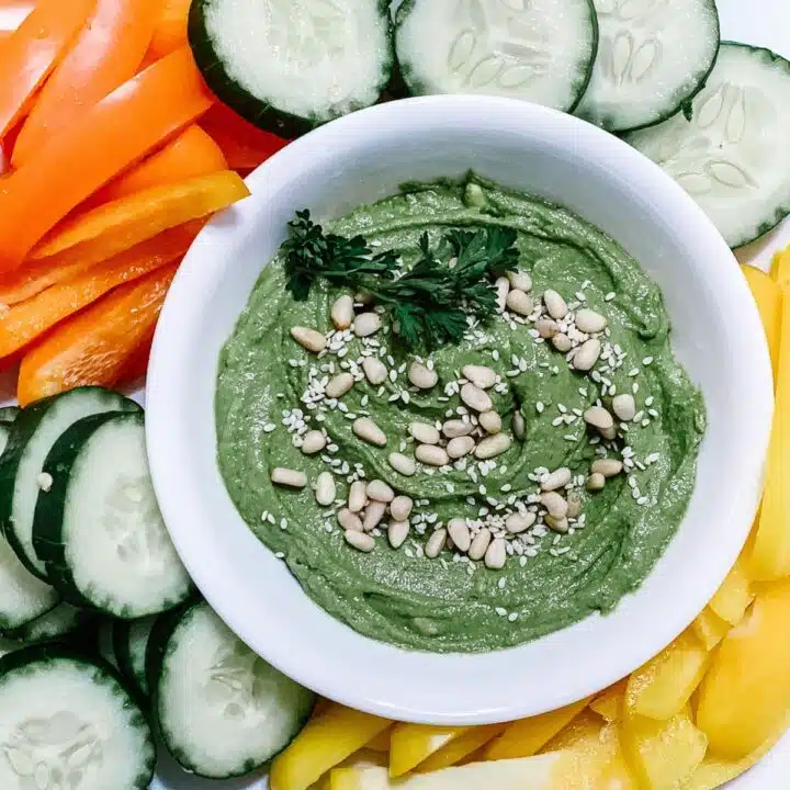 Simple and good green goddess hummus recipe served with fresh vegetables.