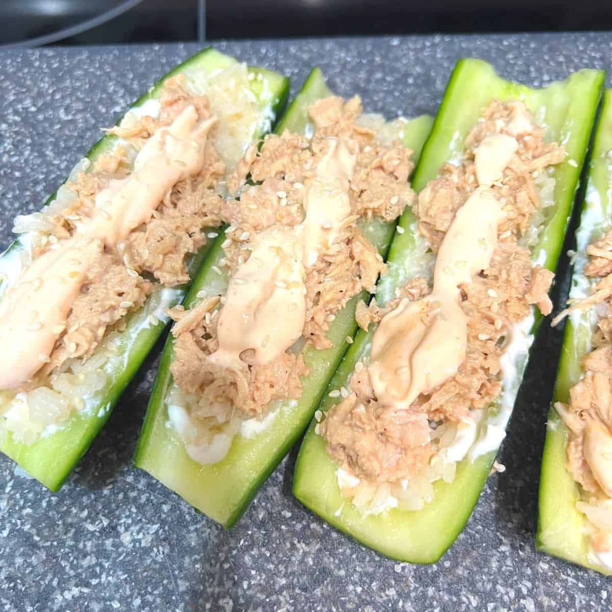 Spread rice evenly over the cucumber. top with tuna mixture. Top with spicy mayo.