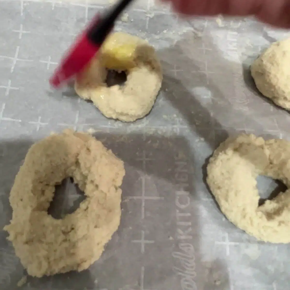 Brush with egg wash if you want that nice golden color on top of your bagels. Sprinkle on toppings of choice