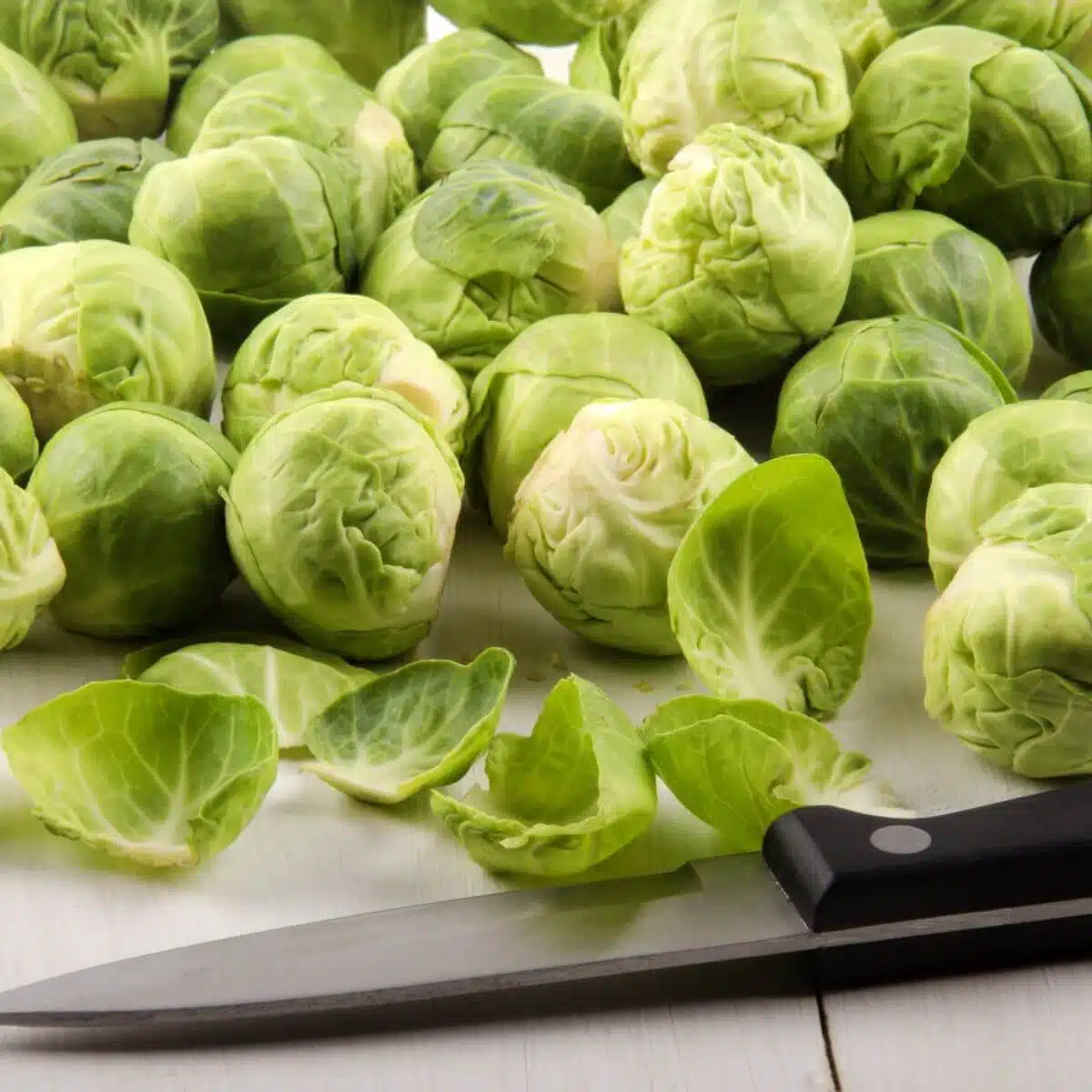 Cube squash, chop onion, trim and halve Brussels sprouts.