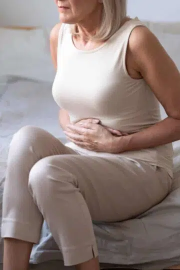 Aging woman and her gut health.