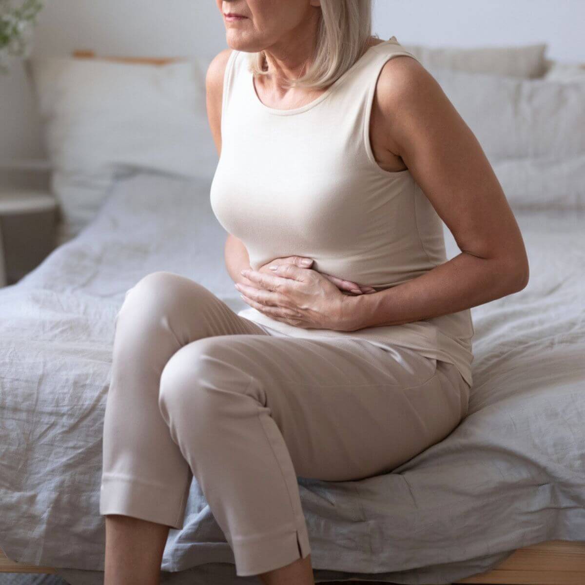 Aging woman and her gut health.
