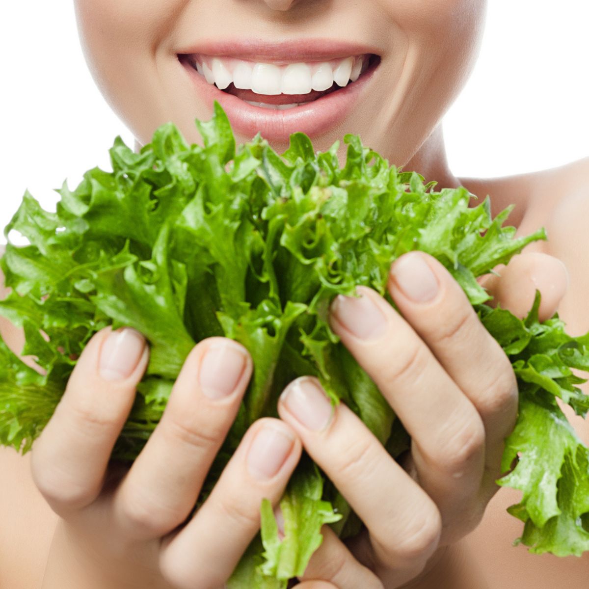 Woman holding lettuce, foods good for skin issues.