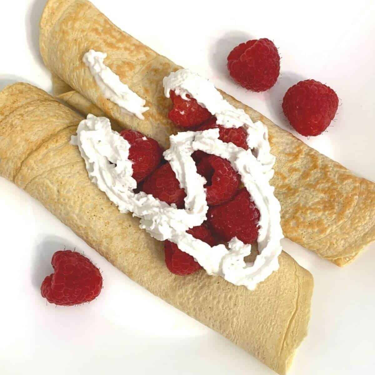 raspberry high protein crepes recipe on a white plate