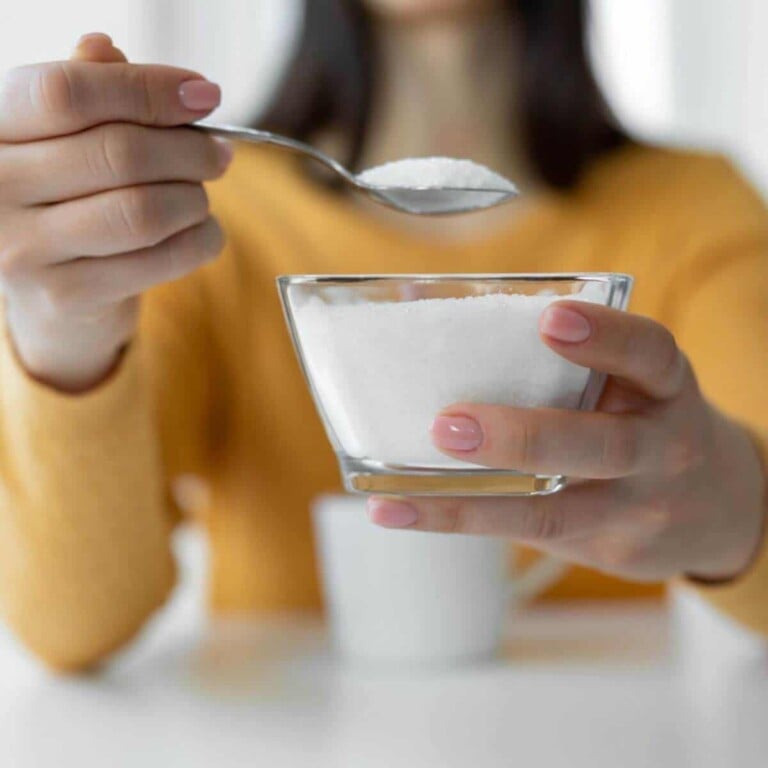 Woman stirring sugar into a glass