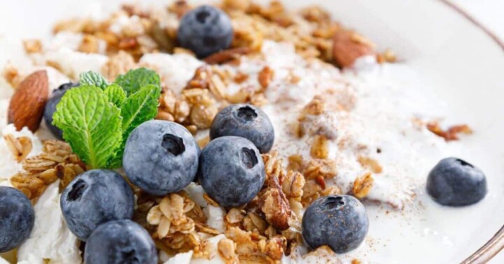 a bowl of granola with blueberries and yogurt